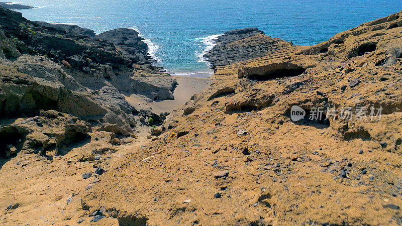 Aerial view of the hidden cove beach "Playa Cumplida" at the natural reserve of "Montaña Pelada" in Tenerife (Canary Islands). Drone shot